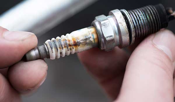 Mechanism behind the spark plug shattering glass
